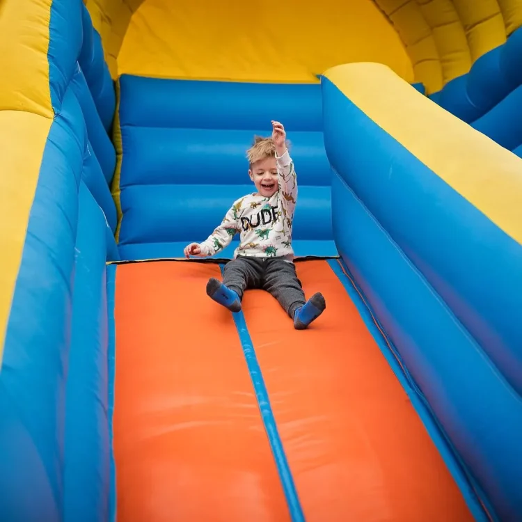 A boy playing in a bouncy castle