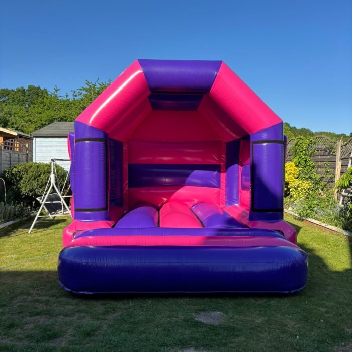 Children jumping and having fun on a garden bouncy castle.
